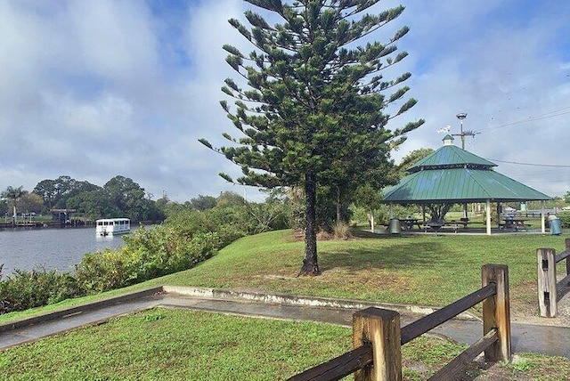 650 NE Waters Edge Ln, Port Saint Lucie, FL 34983 - view of green lawn featuring a gazebo and a water view