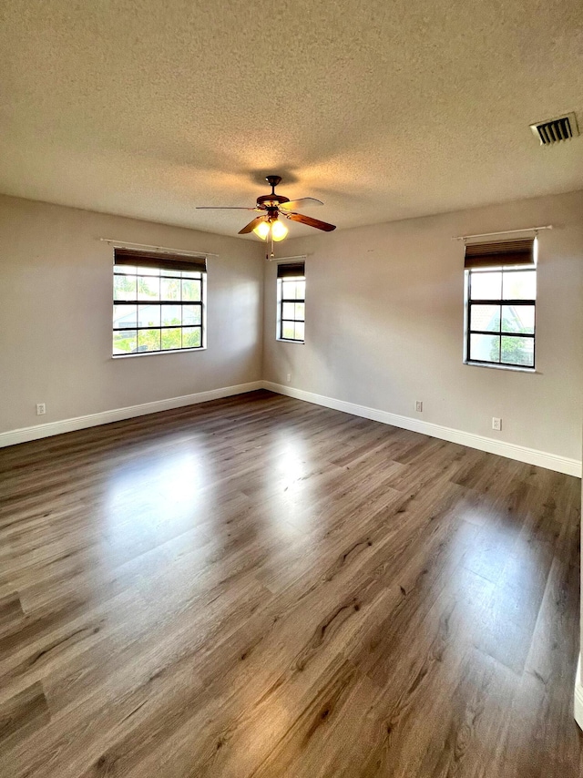 9815 Watermill Cir Unit B, Boynton Beach, FL 33437 - unfurnished room featuring a textured ceiling, dark wood finished floors, and a ceiling fan