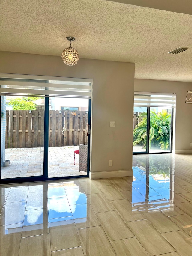 9815 Watermill Cir Unit B, Boynton Beach, FL 33437 - spare room featuring baseboards and a textured ceiling