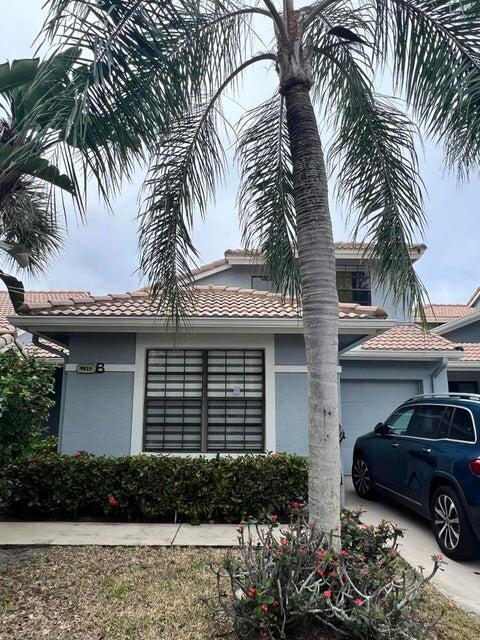 9815 Watermill Cir Unit B, Boynton Beach, FL 33437 - view of front of home with a garage, stucco siding, and a tiled roof