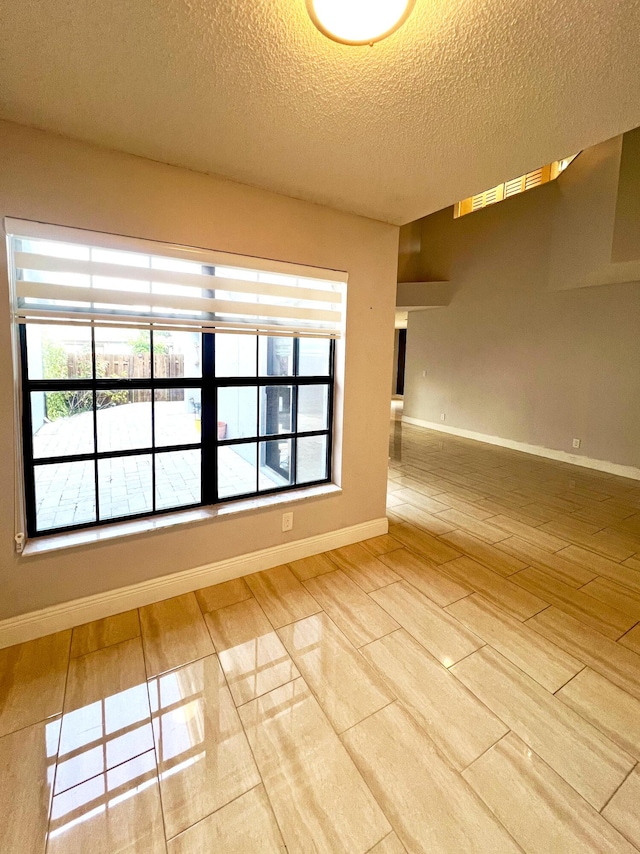 9815 Watermill Cir Unit B, Boynton Beach, FL 33437 - unfurnished room with a textured ceiling and wood finished floors