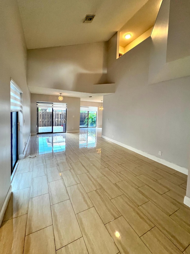 9815 Watermill Cir Unit B, Boynton Beach, FL 33437 - unfurnished room featuring wood finish floors and a towering ceiling