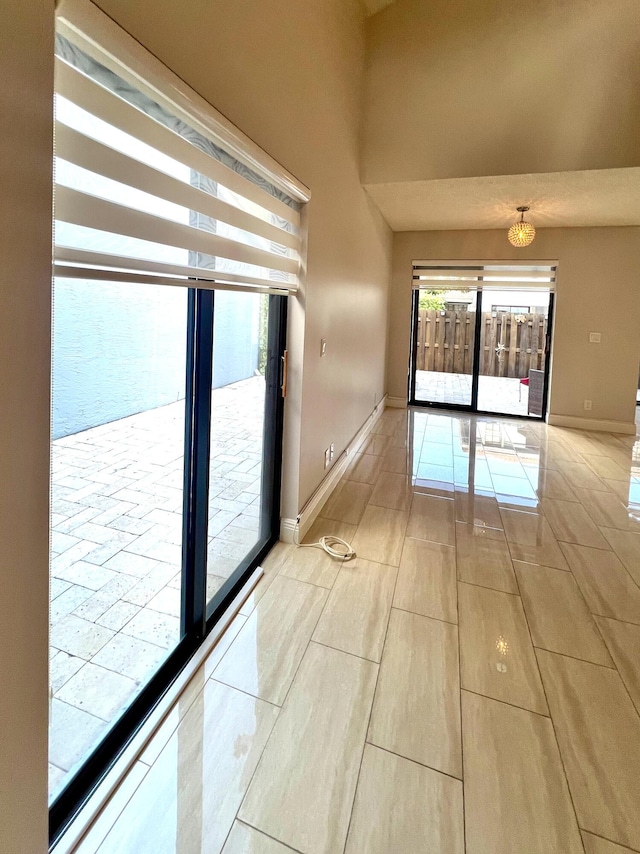 9815 Watermill Cir Unit B, Boynton Beach, FL 33437 - empty room featuring baseboards and a chandelier
