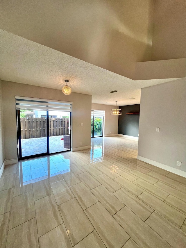 9815 Watermill Cir Unit B, Boynton Beach, FL 33437 - unfurnished room featuring a chandelier and a textured ceiling