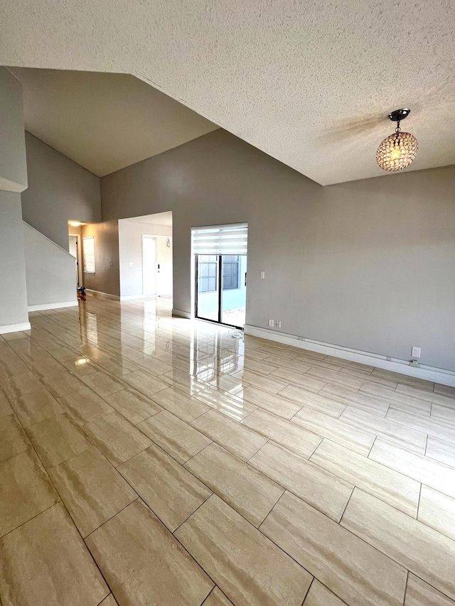 9815 Watermill Cir Unit B, Boynton Beach, FL 33437 - unfurnished room featuring vaulted ceiling and a textured ceiling