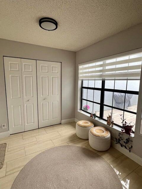 9815 Watermill Cir Unit B, Boynton Beach, FL 33437 - bathroom featuring healthy amount of natural light, a textured ceiling, and tile patterned floors