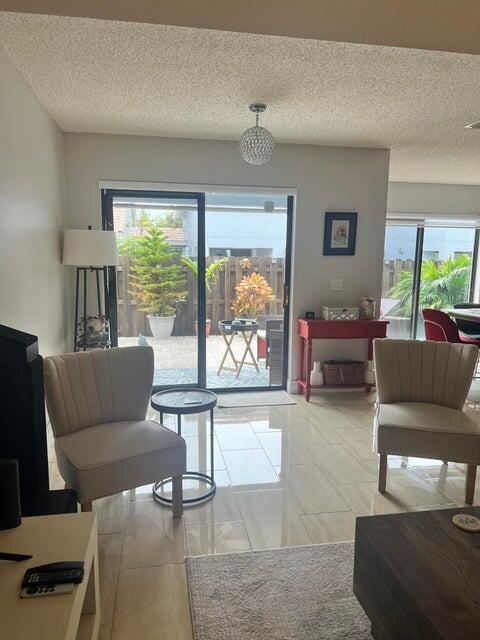 9815 Watermill Cir Unit B, Boynton Beach, FL 33437 - living room with plenty of natural light and a textured ceiling