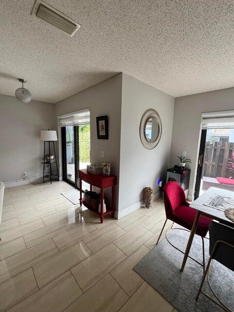 9815 Watermill Cir Unit B, Boynton Beach, FL 33437 - dining room with a textured ceiling and baseboards