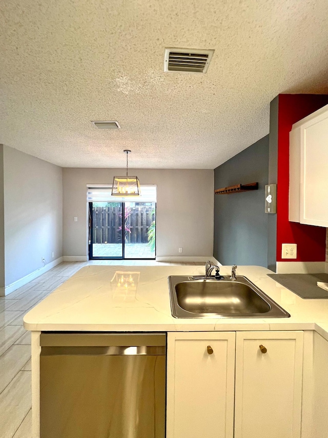 9815 Watermill Cir Unit B, Boynton Beach, FL 33437 - kitchen featuring dishwasher, a textured ceiling, light countertops, white cabinets, and pendant lighting