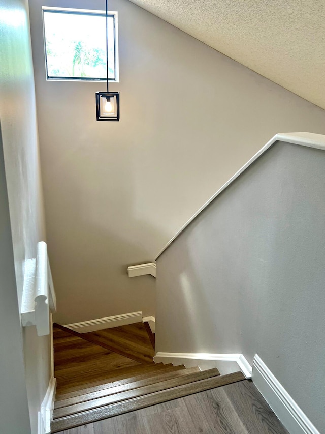 9815 Watermill Cir Unit B, Boynton Beach, FL 33437 - staircase with wood finished floors, a baseboard heating unit, and a textured ceiling