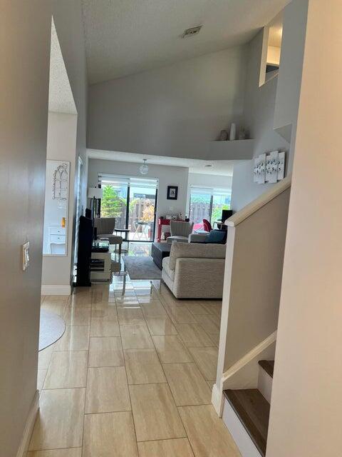 9815 Watermill Cir Unit B, Boynton Beach, FL 33437 - hall featuring stairs, healthy amount of natural light, and a high ceiling