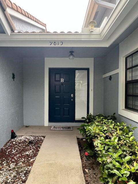 9815 Watermill Cir Unit B, Boynton Beach, FL 33437 - view of exterior entry featuring stucco siding