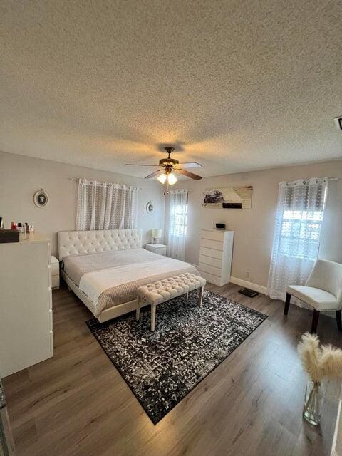9815 Watermill Cir Unit B, Boynton Beach, FL 33437 - bedroom featuring a textured ceiling, wood finished floors, and a ceiling fan
