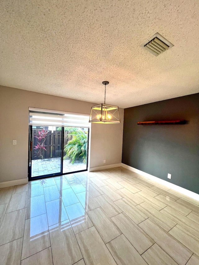 9815 Watermill Cir Unit B, Boynton Beach, FL 33437 - spare room featuring a textured ceiling and a chandelier