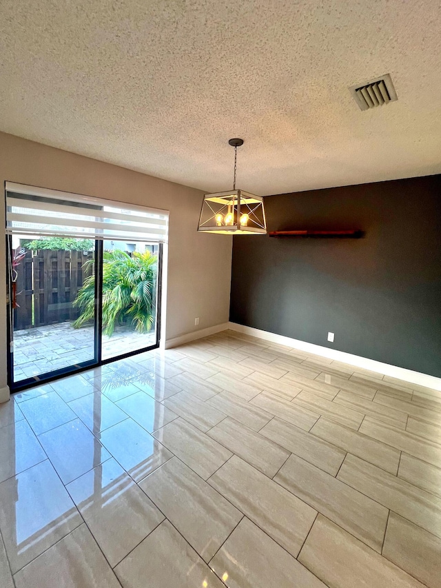 9815 Watermill Cir Unit B, Boynton Beach, FL 33437 - empty room featuring a chandelier and a textured ceiling