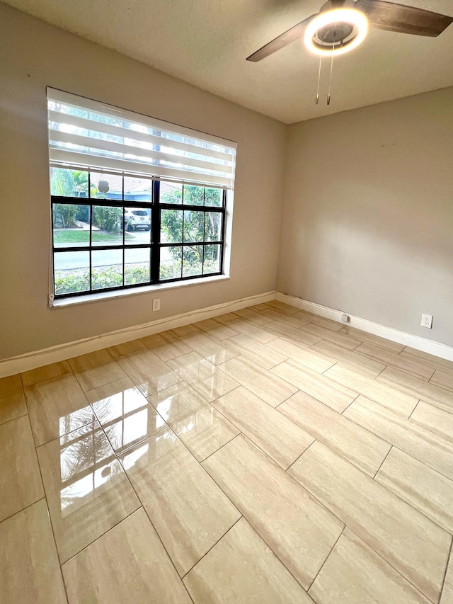 9815 Watermill Cir Unit B, Boynton Beach, FL 33437 - spare room with baseboards and a ceiling fan