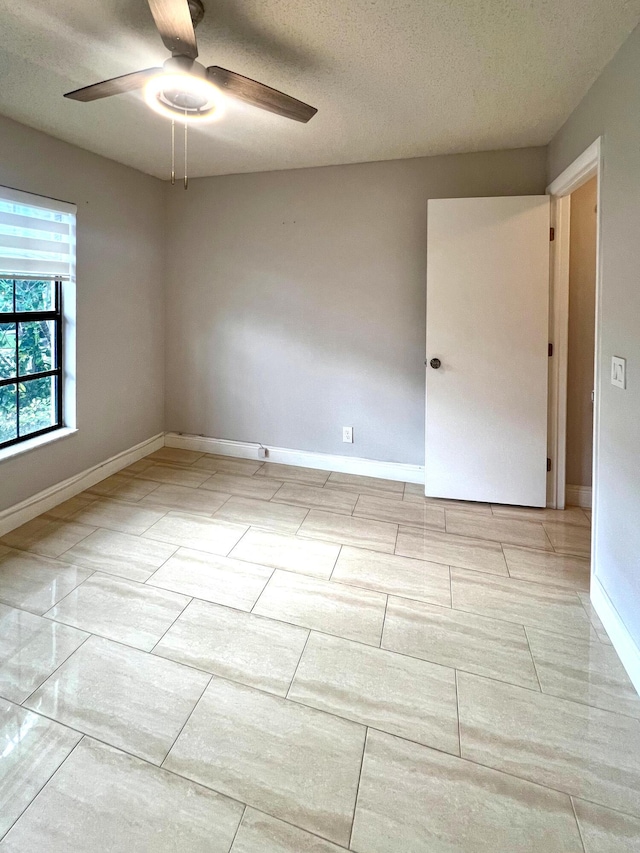 9815 Watermill Cir Unit B, Boynton Beach, FL 33437 - empty room with a ceiling fan and a textured ceiling