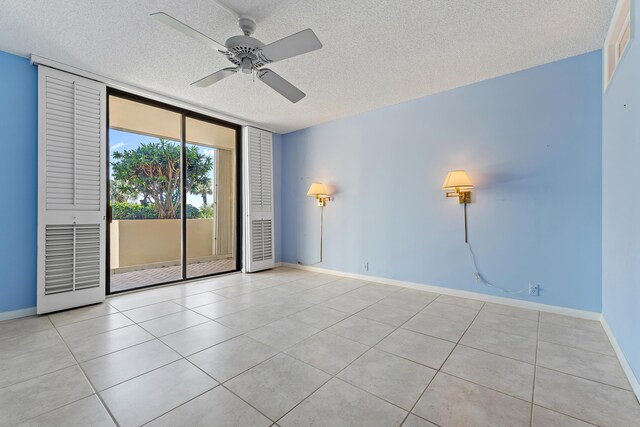 300 Ocean Trail Way Unit 102, Jupiter, FL 33477 - tiled spare room with a textured ceiling, ceiling fan, and a wall of windows