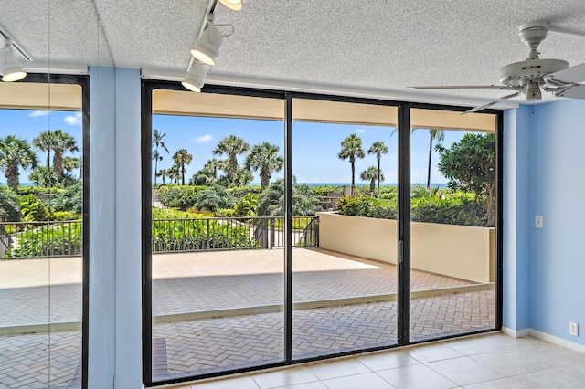 300 Ocean Trail Way Unit 102, Jupiter, FL 33477 - doorway with ceiling fan, tile patterned flooring, plenty of natural light, a textured ceiling, and floor to ceiling windows
