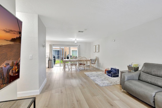 8730 SW 21st St, Miramar, FL 33025 - living room with light wood finished floors and baseboards