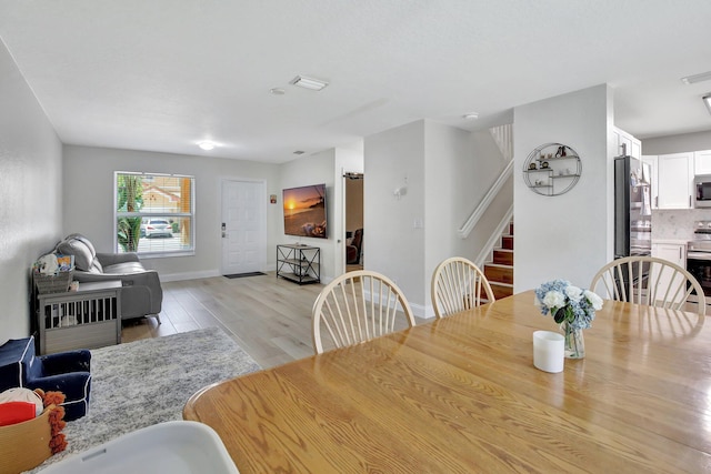 8730 SW 21st St, Miramar, FL 33025 - dining space with stairway and light wood-style flooring