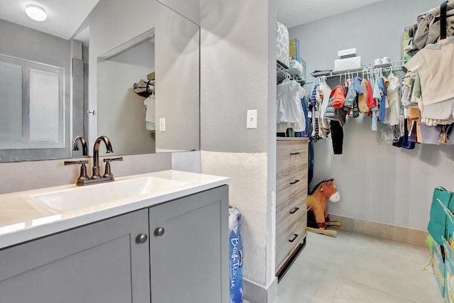 8730 SW 21st St, Miramar, FL 33025 - bathroom featuring vanity, a walk in closet, and tile patterned flooring