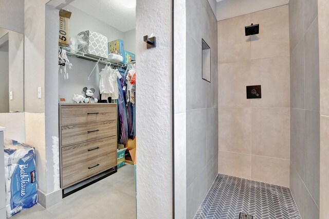 8730 SW 21st St, Miramar, FL 33025 - bathroom featuring tiled shower and a walk in closet