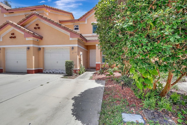 8730 SW 21st St, Miramar, FL 33025 - view of front facade featuring stucco siding, a garage, driveway, and a tile roof