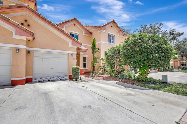 8730 SW 21st St, Miramar, FL 33025 - view of front of home featuring stucco siding, a garage, and driveway