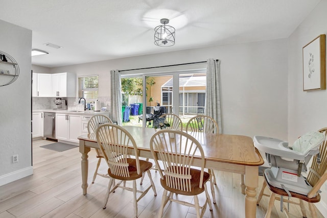 8730 SW 21st St, Miramar, FL 33025 - dining room with light wood-style flooring and baseboards