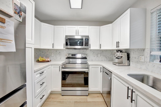 8730 SW 21st St, Miramar, FL 33025 - kitchen featuring appliances with stainless steel finishes, white cabinetry, and backsplash