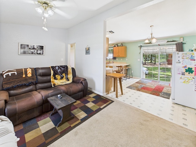 7281 NW 90th Ct, Okeechobee, FL 34972 - living area featuring light colored carpet, ceiling fan, and a chandelier