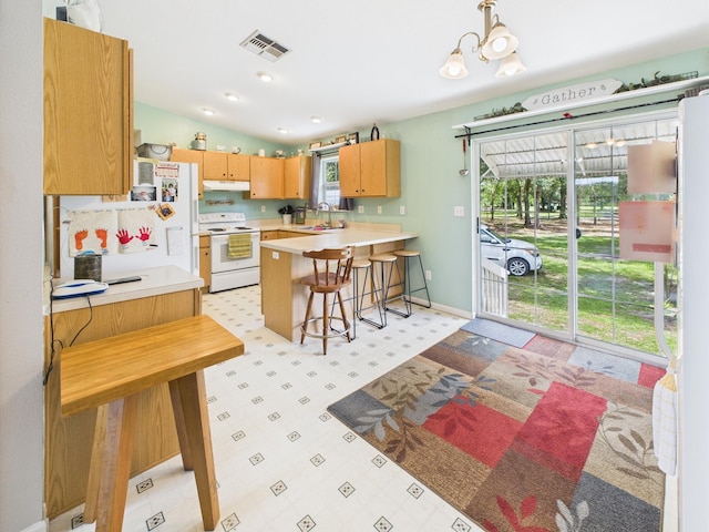 7281 NW 90th Ct, Okeechobee, FL 34972 - kitchen with white range with electric cooktop, under cabinet range hood, healthy amount of natural light, light countertops, and lofted ceiling