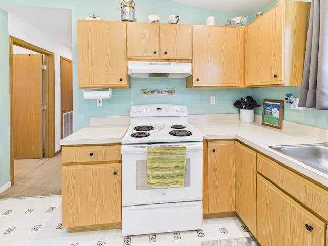 7281 NW 90th Ct, Okeechobee, FL 34972 - kitchen with white electric range, under cabinet range hood, light countertops, and light brown cabinetry