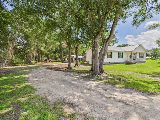 7281 NW 90th Ct, Okeechobee, FL 34972 - view of front of house with crawl space, a front lawn, a metal roof, and covered porch