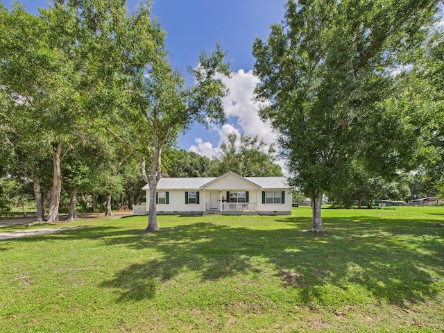 7281 NW 90th Ct, Okeechobee, FL 34972 - single story home featuring a front lawn, a metal roof, and covered porch