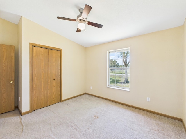 7281 NW 90th Ct, Okeechobee, FL 34972 - unfurnished bedroom featuring vaulted ceiling, carpet, a closet, and ceiling fan