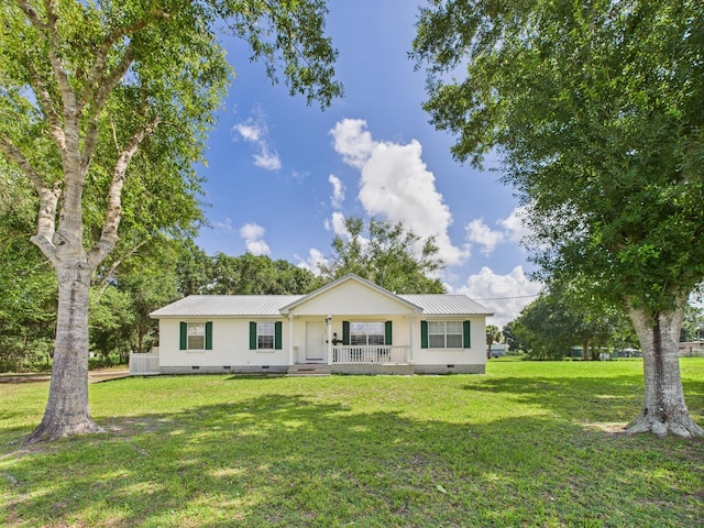 7281 NW 90th Ct, Okeechobee, FL 34972 - ranch-style home with crawl space, covered porch, a front yard, and a metal roof