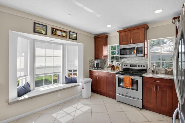 11814 N Lake Dr, Boynton Beach, FL 33436 - kitchen featuring stainless steel appliances, healthy amount of natural light, decorative backsplash, recessed lighting, and light tile patterned floors