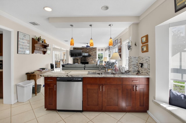 11814 N Lake Dr, Boynton Beach, FL 33436 - kitchen with stainless steel dishwasher, open floor plan, tasteful backsplash, decorative light fixtures, and a stone fireplace