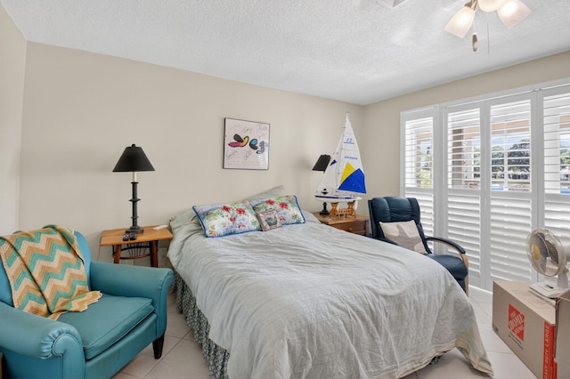 11814 N Lake Dr, Boynton Beach, FL 33436 - tiled bedroom with a textured ceiling and ceiling fan