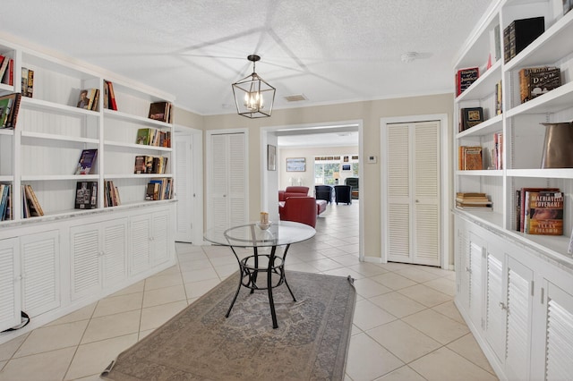 11814 N Lake Dr, Boynton Beach, FL 33436 - dining room with ornamental molding, light tile patterned flooring, a chandelier, and a textured ceiling