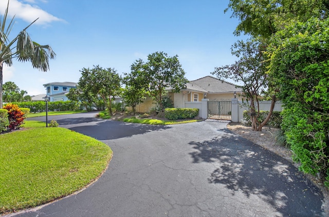 11814 N Lake Dr, Boynton Beach, FL 33436 - view of front of property featuring asphalt driveway and a gate