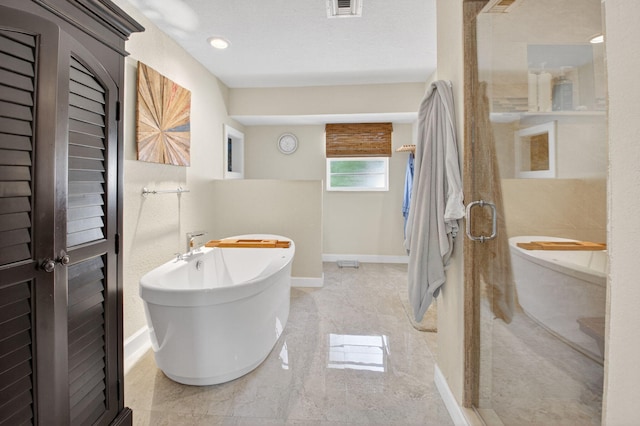 11814 N Lake Dr, Boynton Beach, FL 33436 - bathroom with a freestanding tub and baseboards