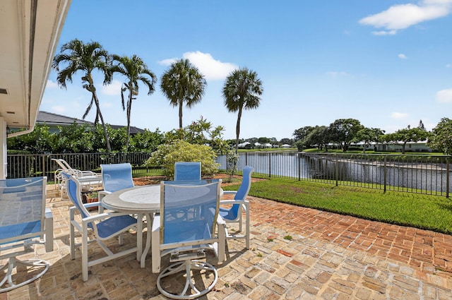 11814 N Lake Dr, Boynton Beach, FL 33436 - fenced backyard featuring a patio area, a water view, and outdoor dining space
