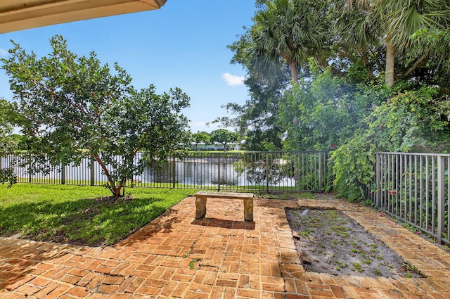 11814 N Lake Dr, Boynton Beach, FL 33436 - fenced backyard with a water view and a patio area