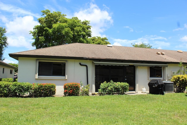 4660 Finchwood Ter Unit B, Boynton Beach, FL 33436 - rear view of house with stucco siding, a yard, and a shingled roof