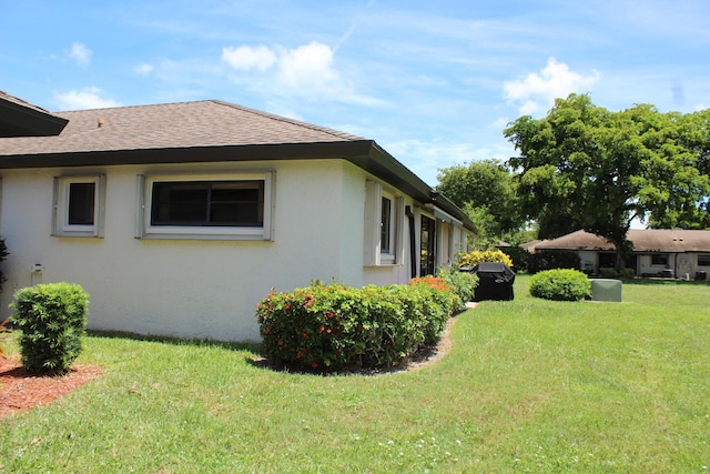 4660 Finchwood Ter Unit B, Boynton Beach, FL 33436 - view of property exterior with roof with shingles, a lawn, and stucco siding