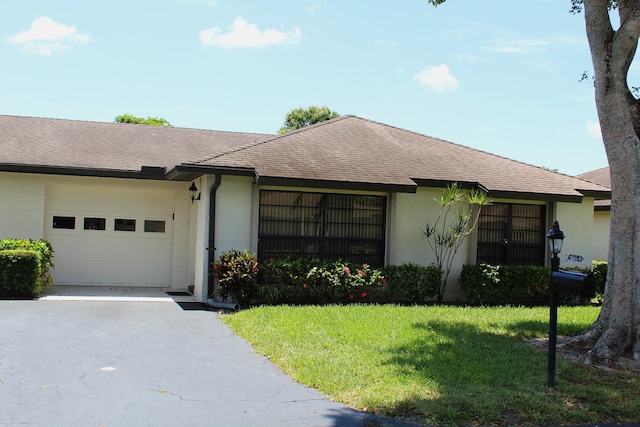 4660 Finchwood Ter Unit B, Boynton Beach, FL 33436 - single story home featuring asphalt driveway, an attached garage, stucco siding, and a front yard