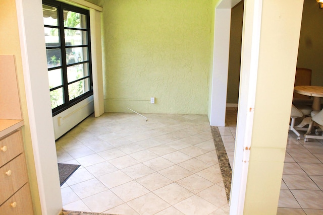 4660 Finchwood Ter Unit B, Boynton Beach, FL 33436 - empty room featuring plenty of natural light, a textured wall, and light tile patterned floors